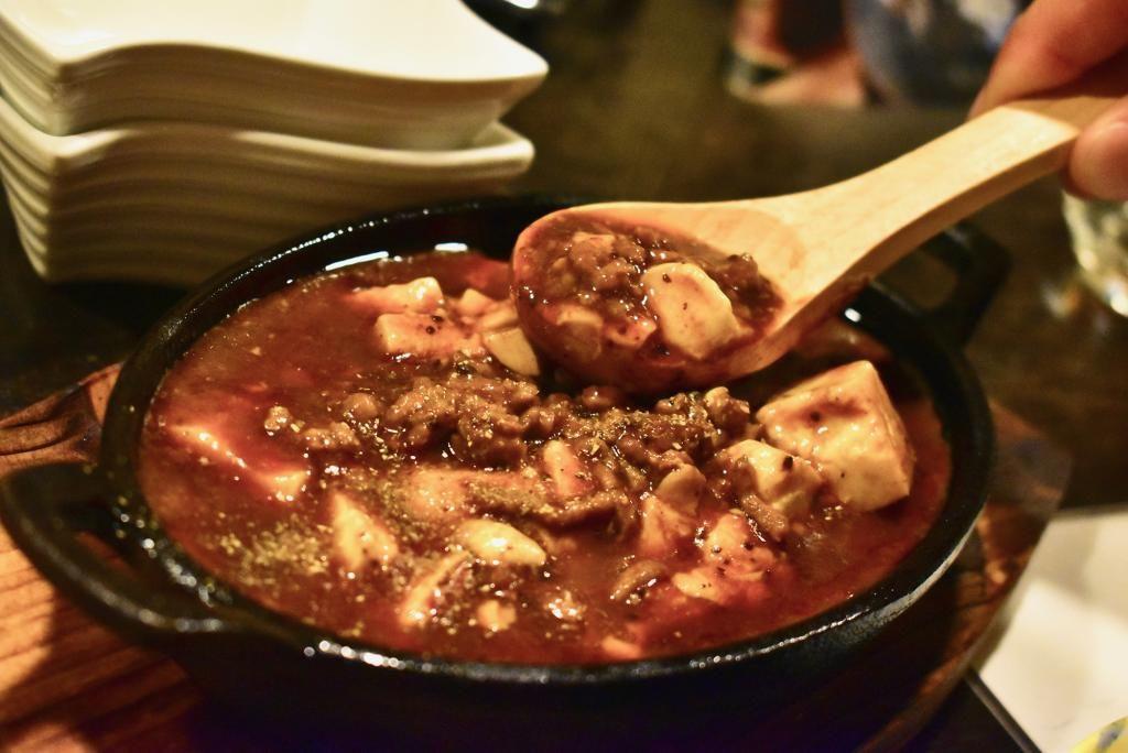 Served on a hot iron plate, the taste of her Mapo Dofu is gently spicy.